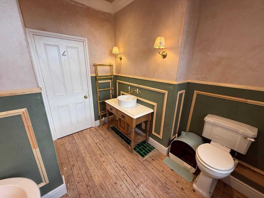 Green painted wall panelling with gold beading, made and fitted on site