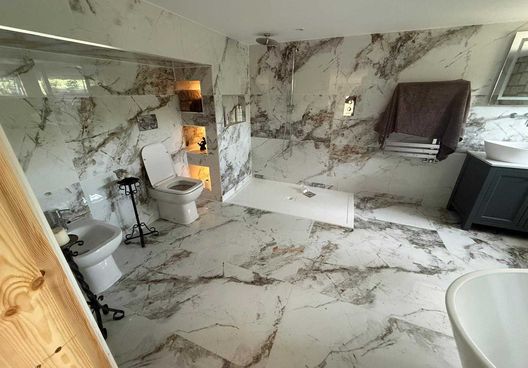 Marble tiled bathroom with a walk-in shower